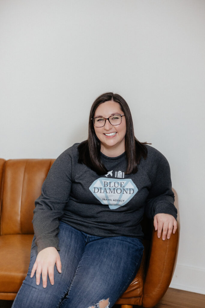 Brandi sitting in a chair with a white background