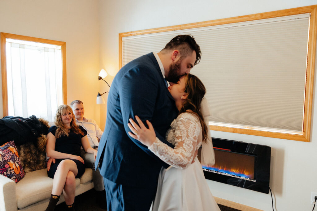 bride and groom sharing a first dance inside a cabin